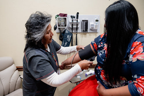 A native woman getting checked by an indigenous nurse