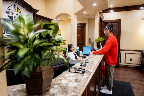 A young Native Man signing into a health clinic