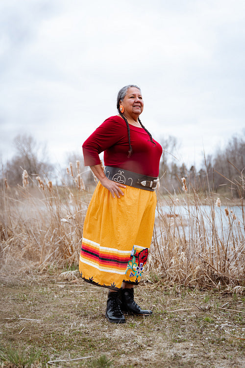 Indigenous elder woman on lake shore