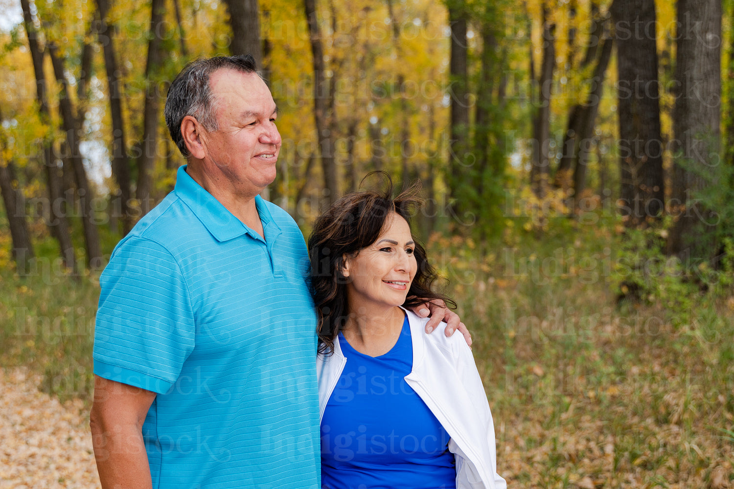 Middle aged Native couple taking a walk through the woods