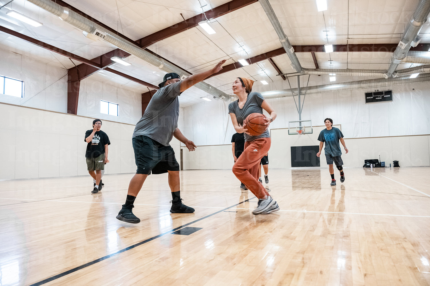 A Native family playing a game of basketball 