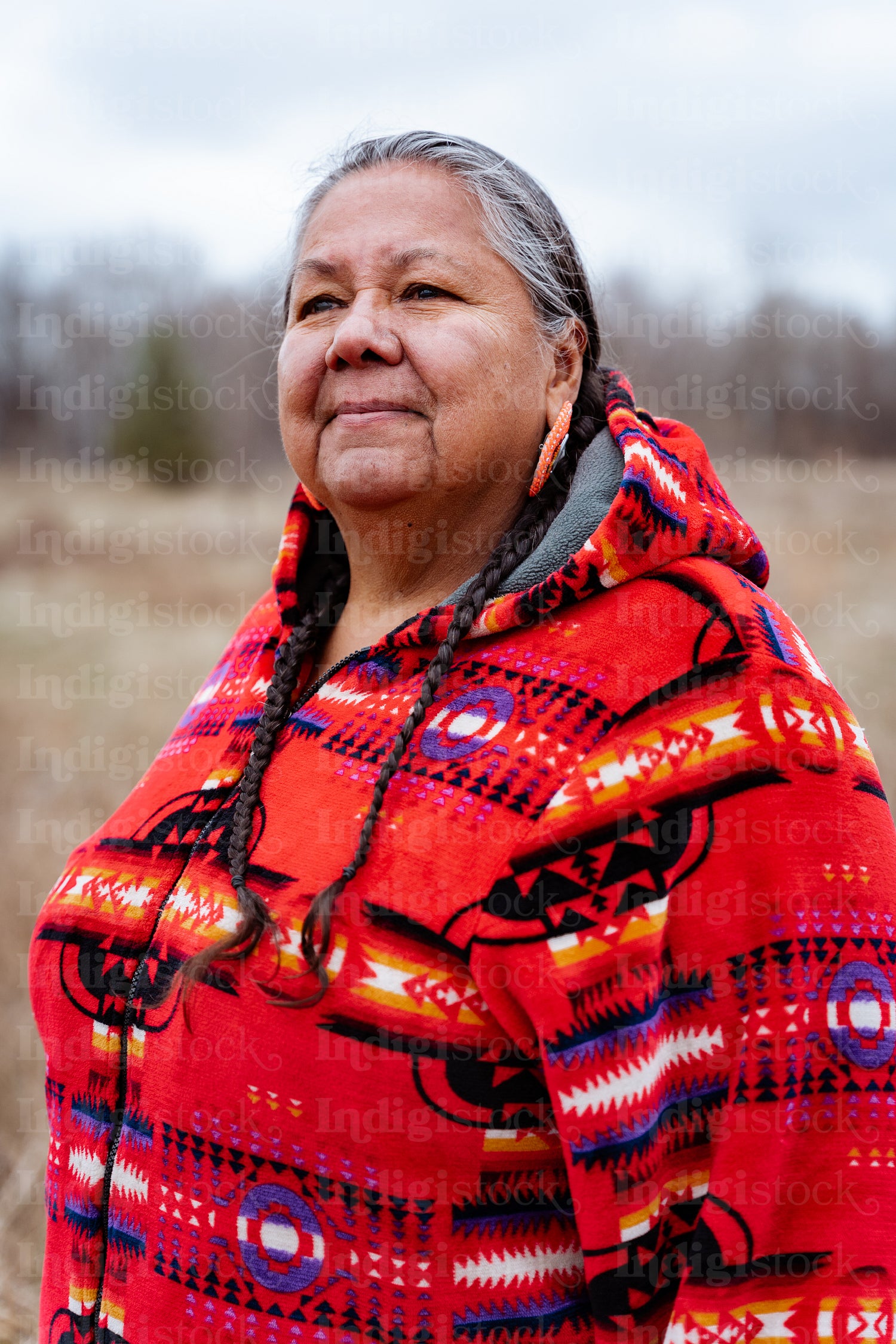 Indigenous elder woman on lake shore