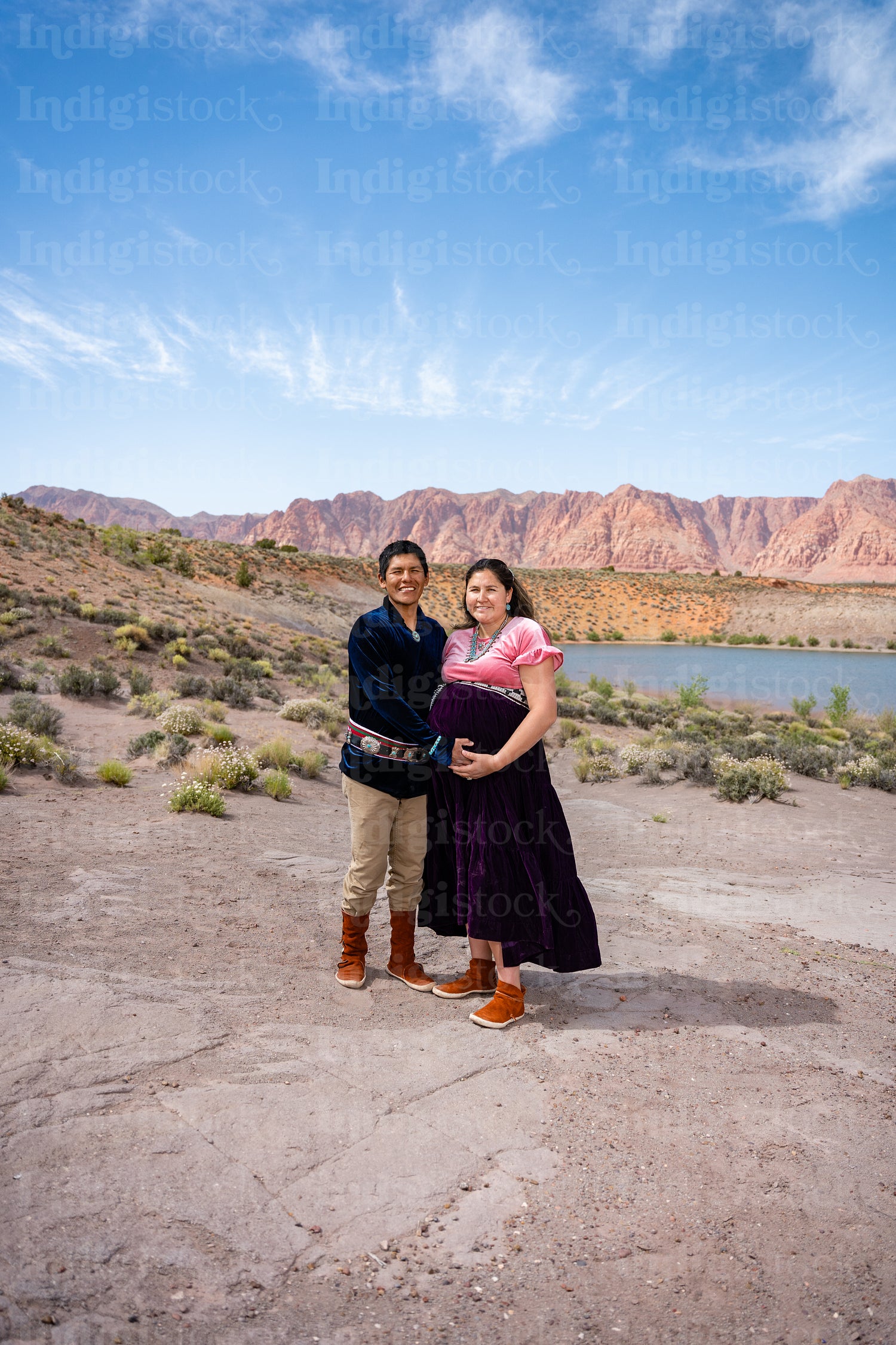 Expecting Native couple wearing traditional regalia clothing out