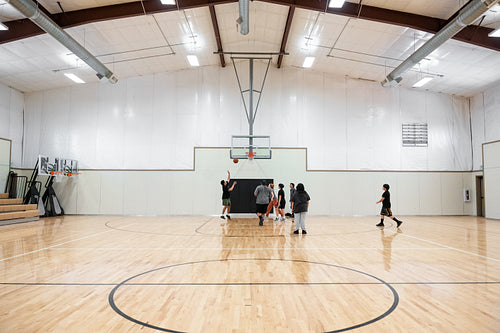 A Native family playing a game of basketball