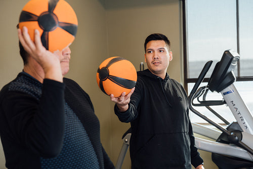 Indigenous men working out at gym