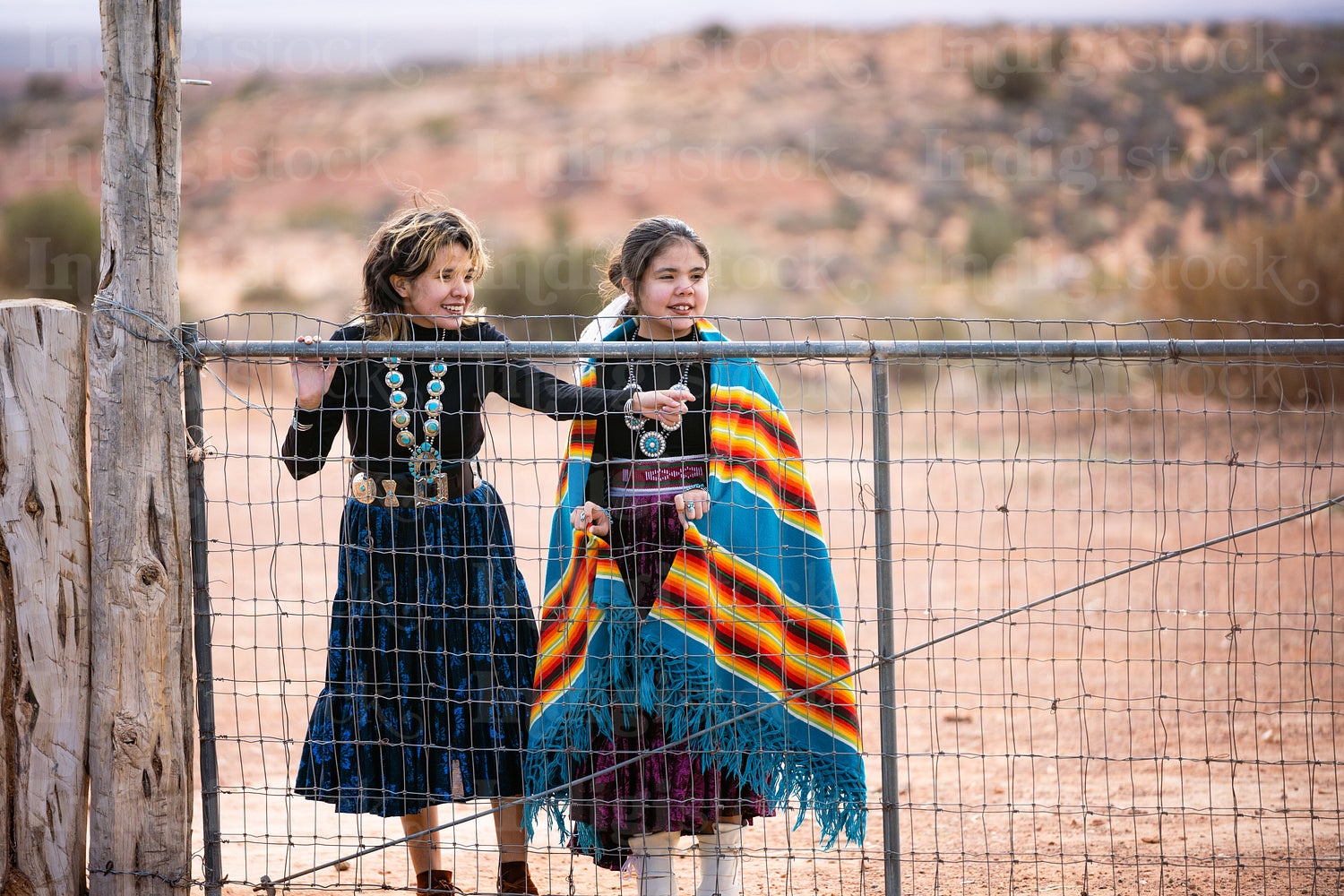 Young native youth wearing traditional regalia outside 