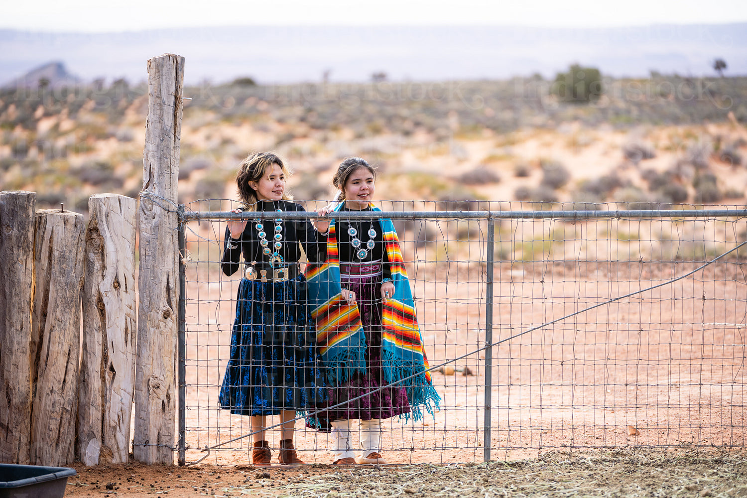 Young native youth wearing traditional regalia outside 