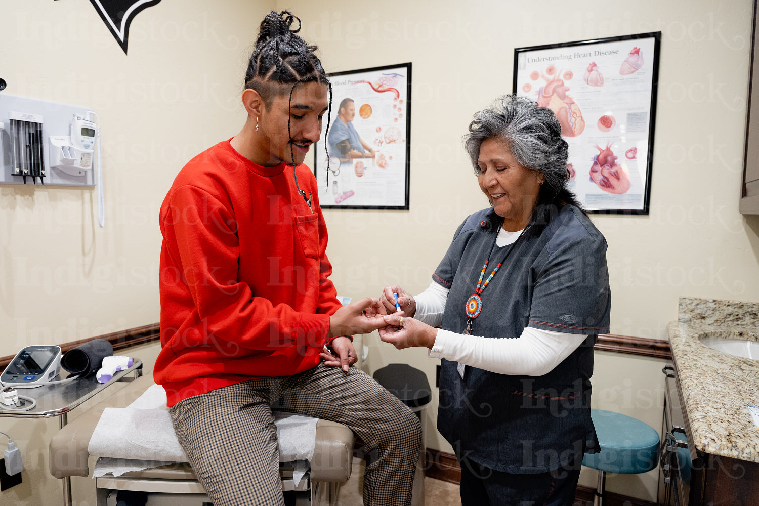 An Indigenous man being check by a native health care nurse