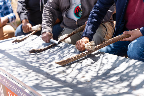 Native men singing songs and playing instruments