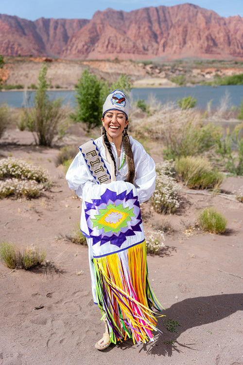 A young Native woman in traditional clothing and regalia