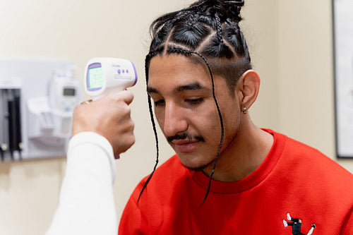 An Indigenous man being check by a native health care nurse