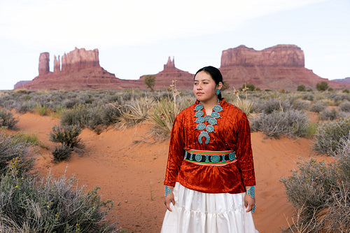 Young Native youth wearing traditional clothing and regalia outs