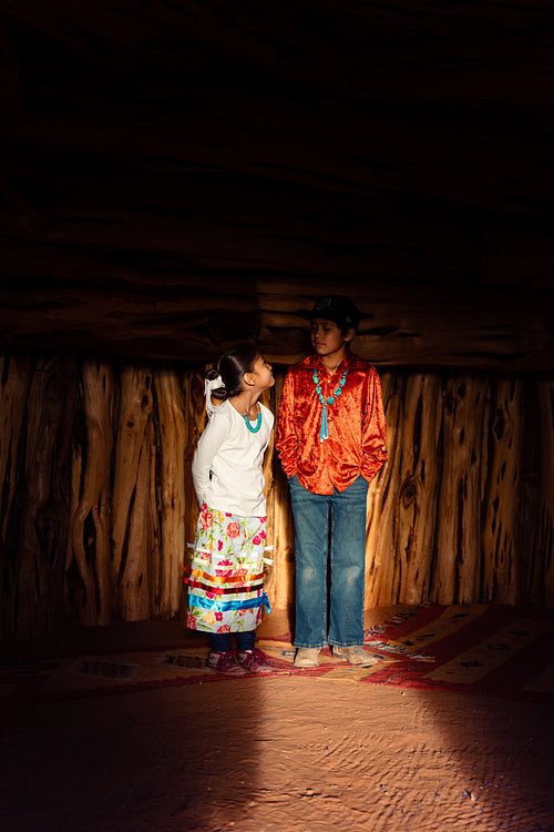 Native American children wearing traditional regalia