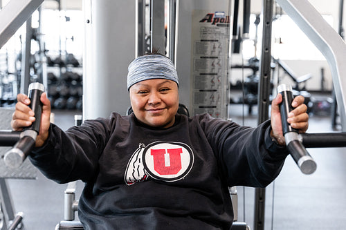 A Indigenous woman working out in a gym