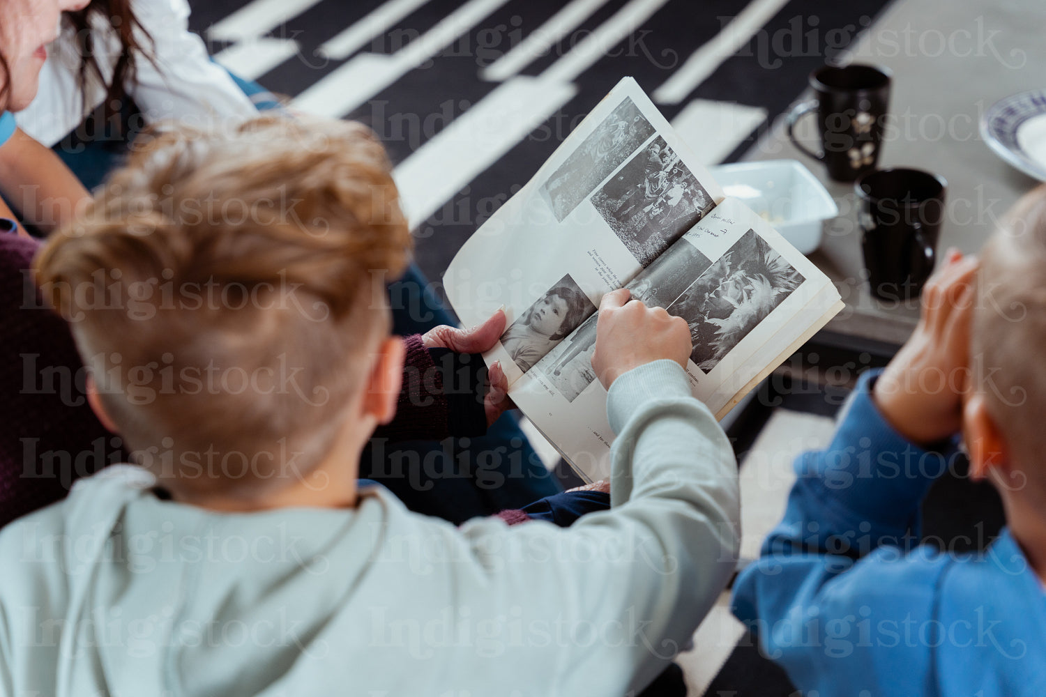 A family of Native Peoples reading a book together