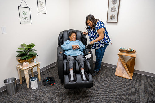 Native Elder relaxing in message chair at health center