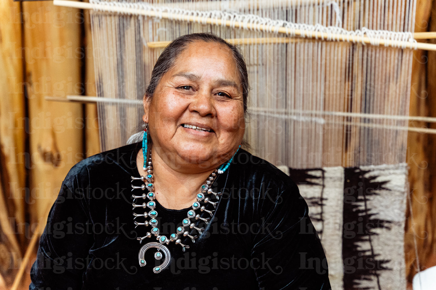 Indigenous woman weaving a traditional pattern in Hogan Earthlod