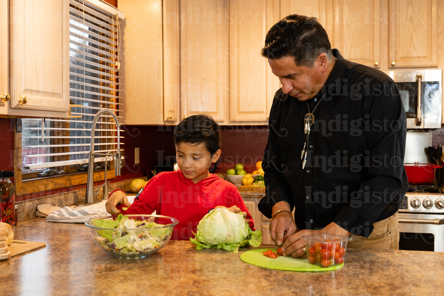 Father and son chopping vegetables