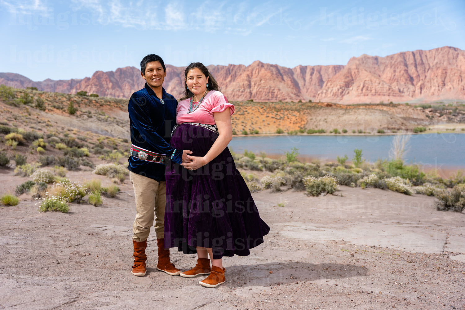 Expecting Native couple wearing traditional regalia clothing out