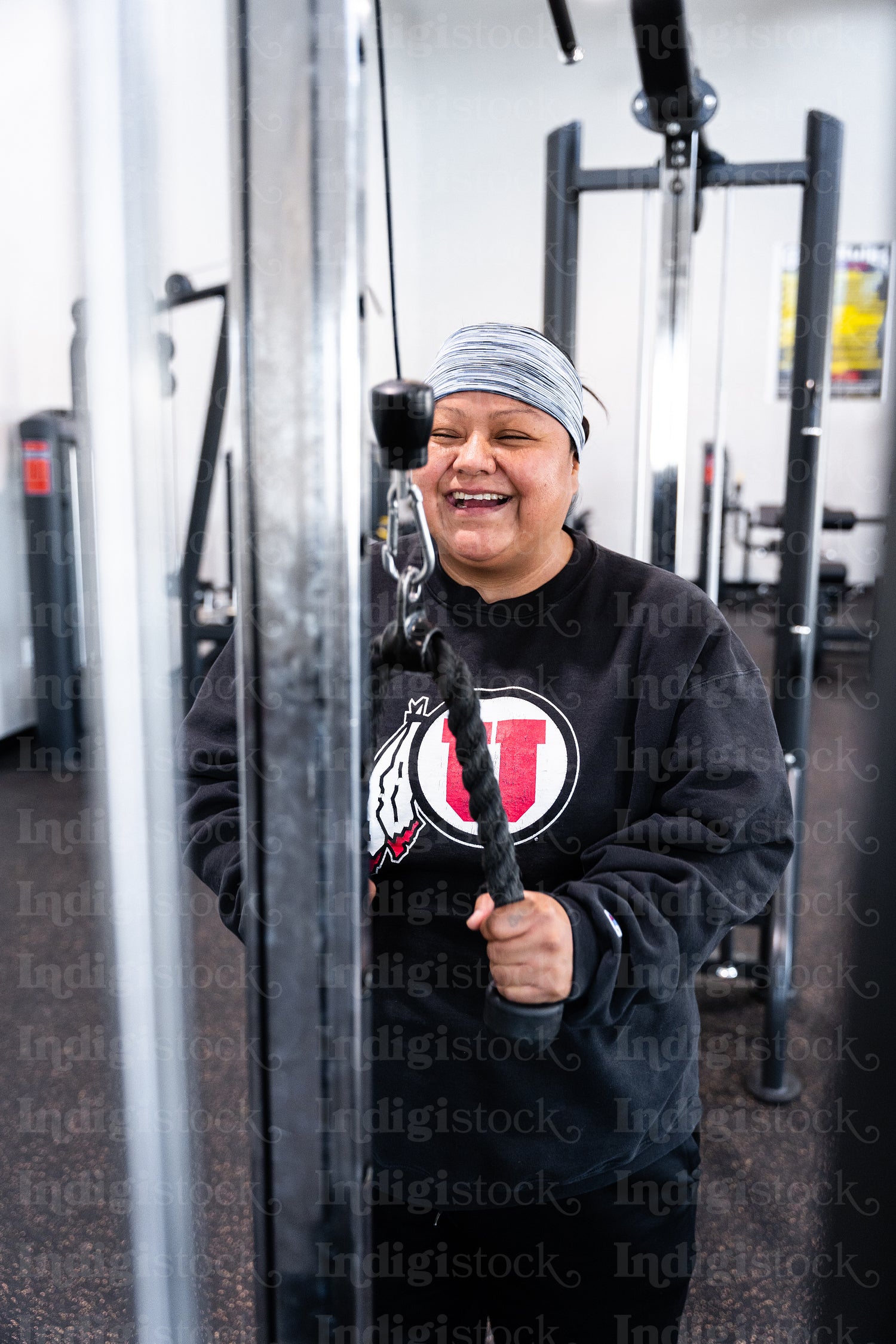 A Indigenous woman working out in a gym