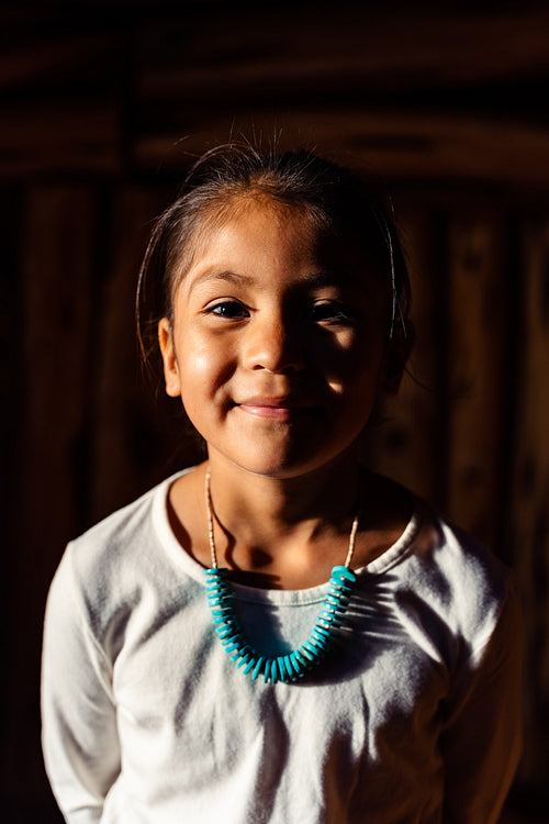 Native American children wearing traditional regalia