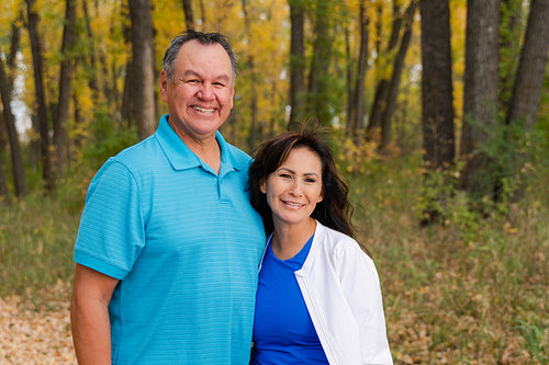 Middle aged Native couple taking a walk through the woods