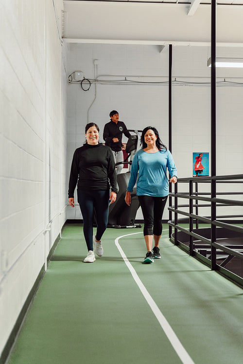 Indigenous women walking on a track