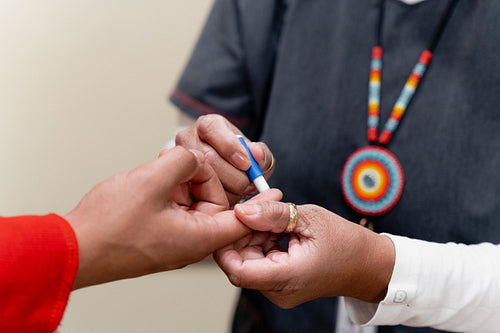 An Indigenous man being check by a native health care nurse