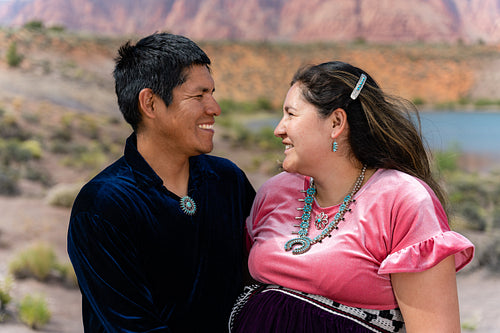 Expecting Native couple wearing traditional regalia clothing out