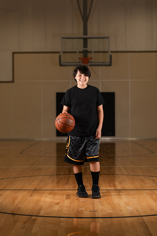 Native youth playing basketball