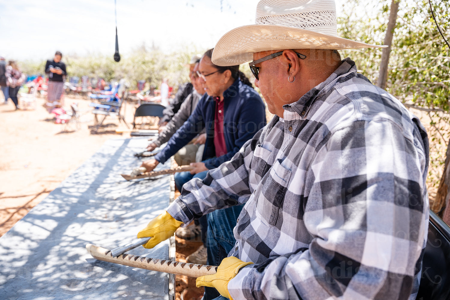 Native men singing songs and playing instruments