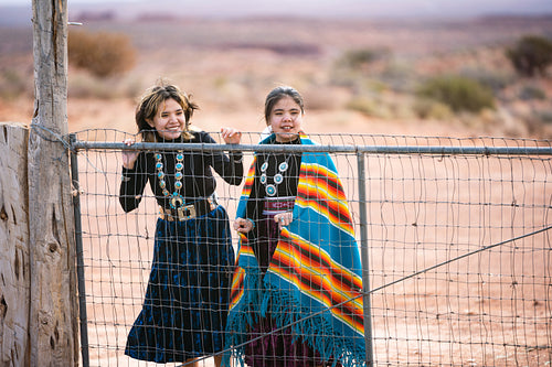 Young native youth wearing traditional regalia outside