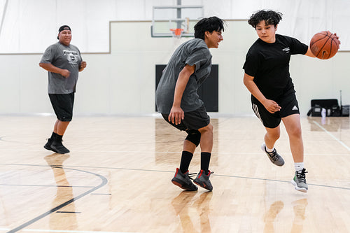 A Native family playing a game of basketball