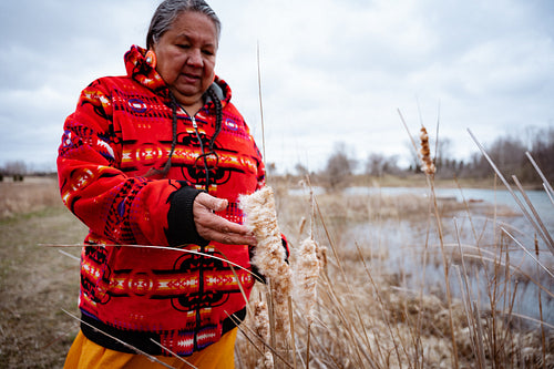 Indigenous elder woman on lake shore