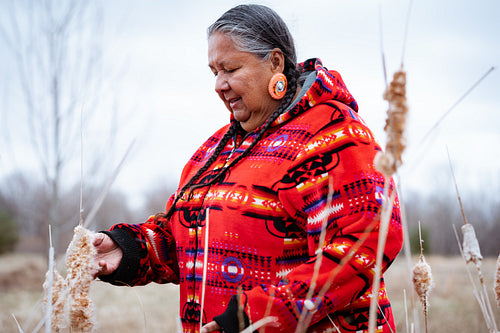 Indigenous elder woman on lake shore