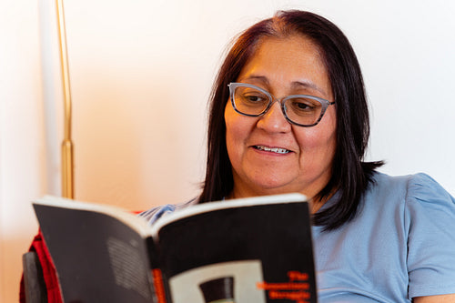 An elder reading a book