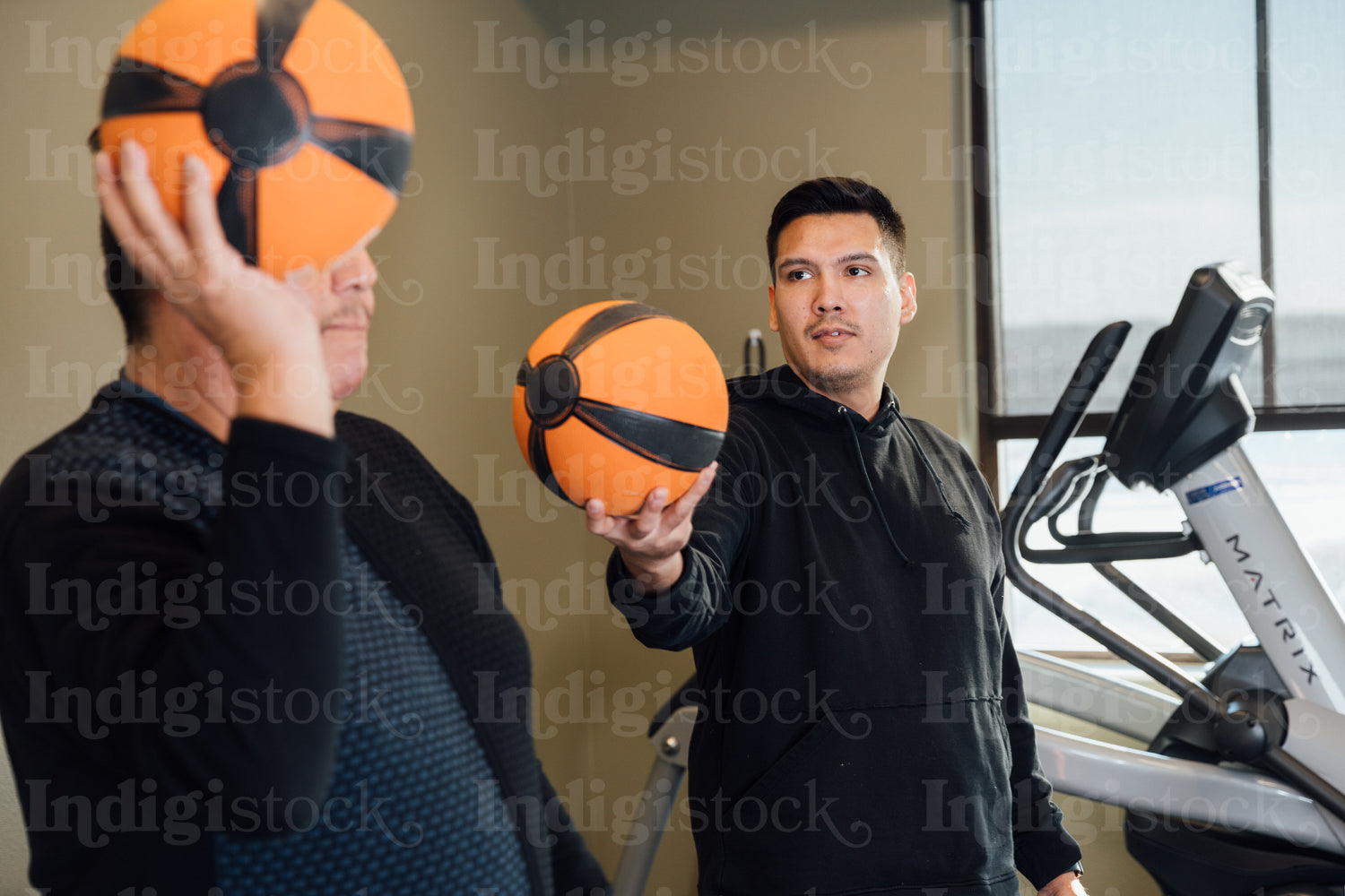 Indigenous men working out at gym