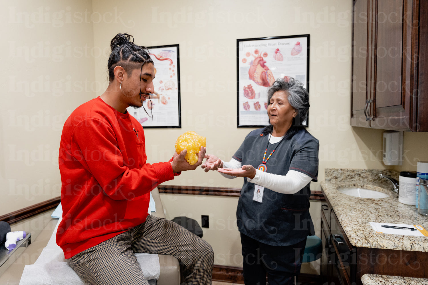 An Indigenous man being check by a native health care nurse