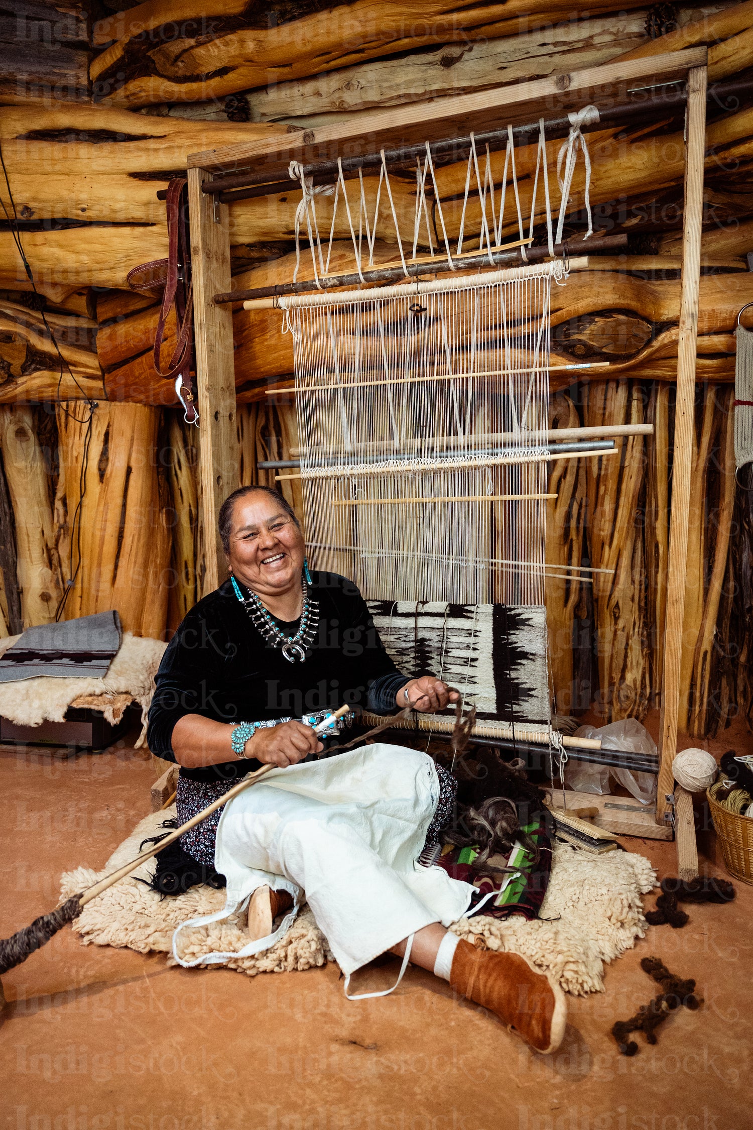 Indigenous woman weaving a traditional pattern in Hogan Earthlod