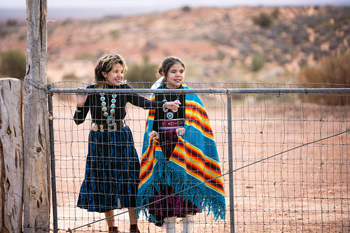 Young native youth wearing traditional regalia outside