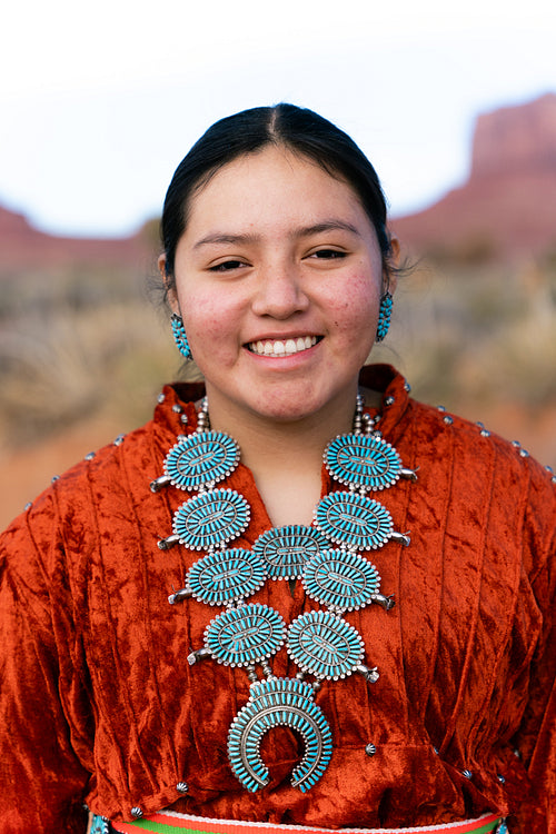 Young Native youth wearing traditional clothing and regalia outs