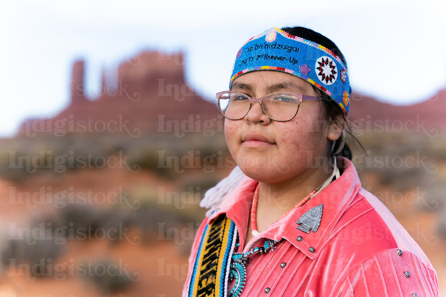 Young Native youth wearing traditional clothing and regalia outs