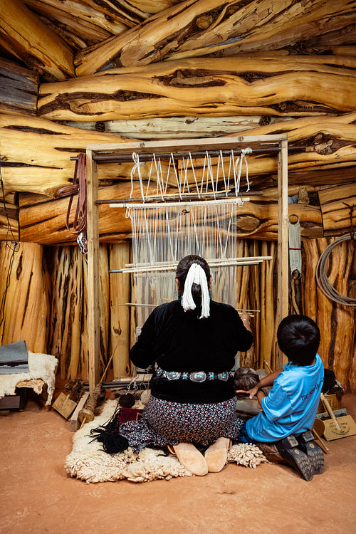 Native Elder showing younger generation the process of tradition