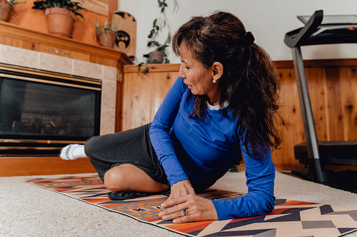 Indigenous woman working out in home gym