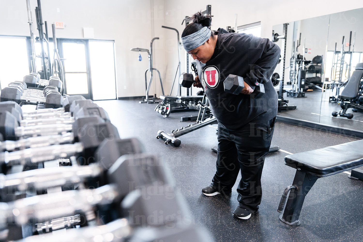 A Indigenous woman working out in a gym