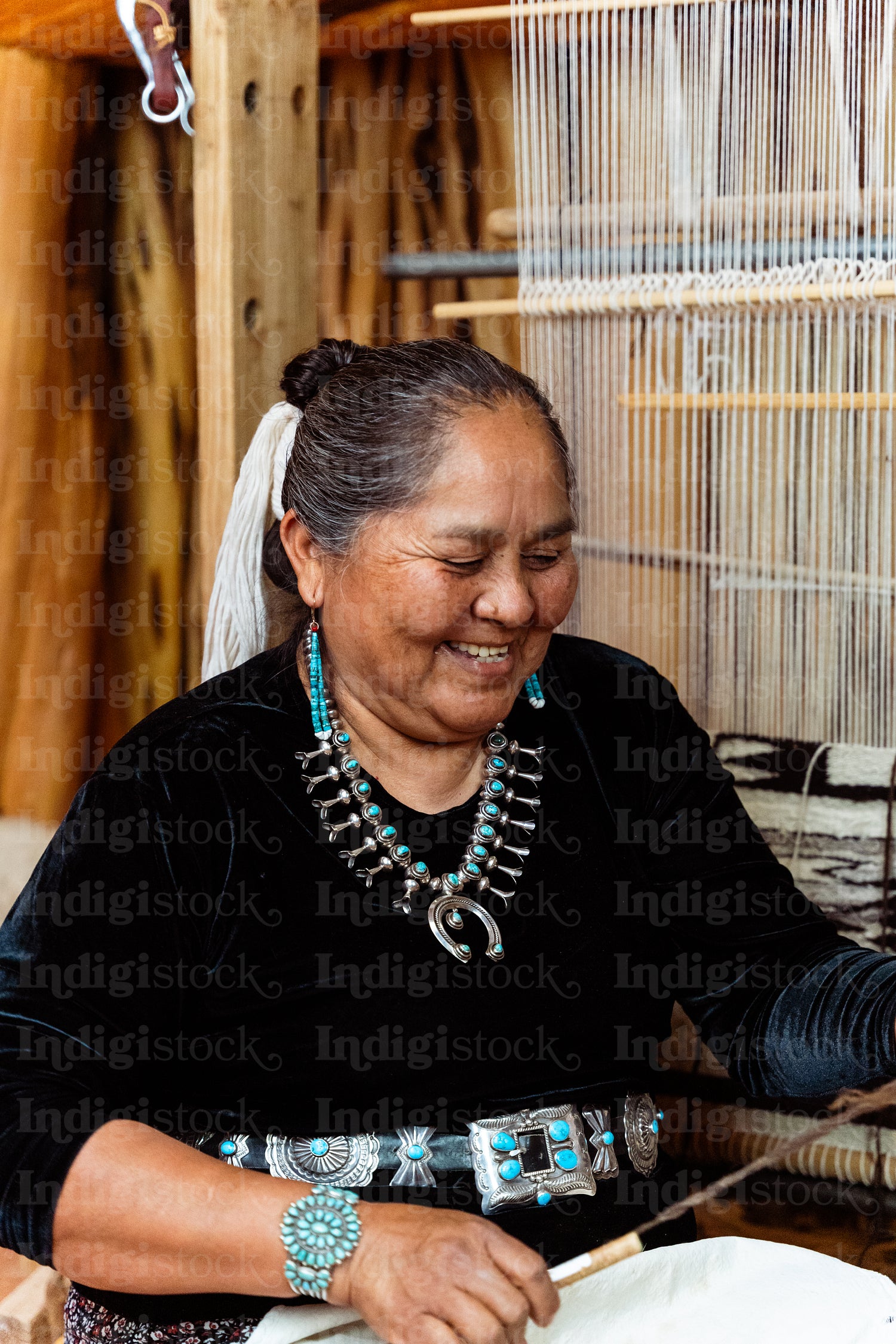 Indigenous woman weaving a traditional pattern in Hogan Earthlod