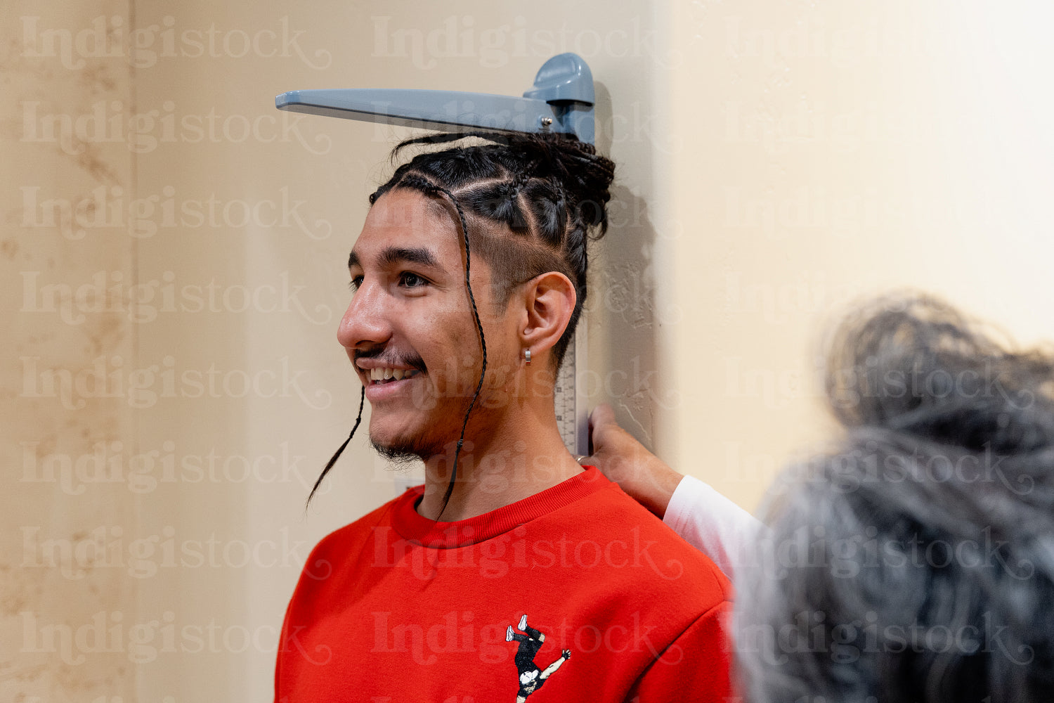 An Indigenous man being check by a native health care nurse