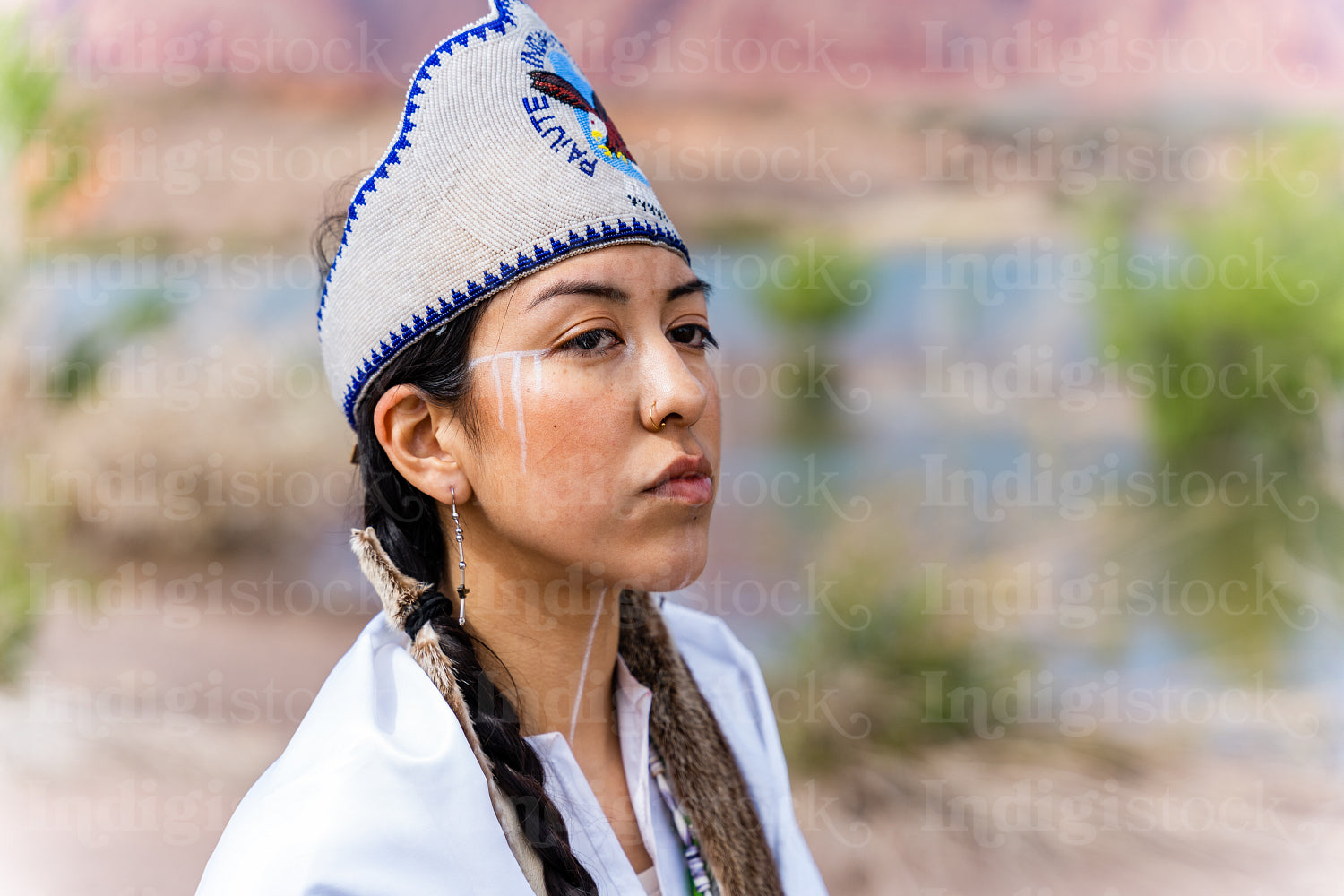 A young Native woman in traditional clothing and regalia 