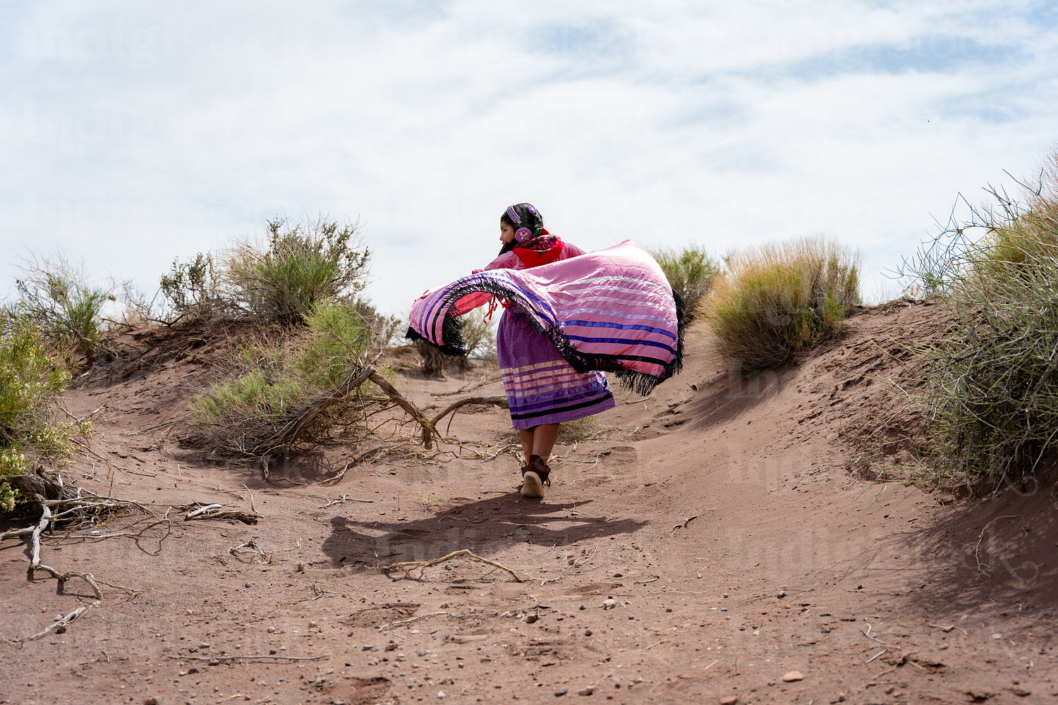 Young Native girl wearing traditional regalia outside