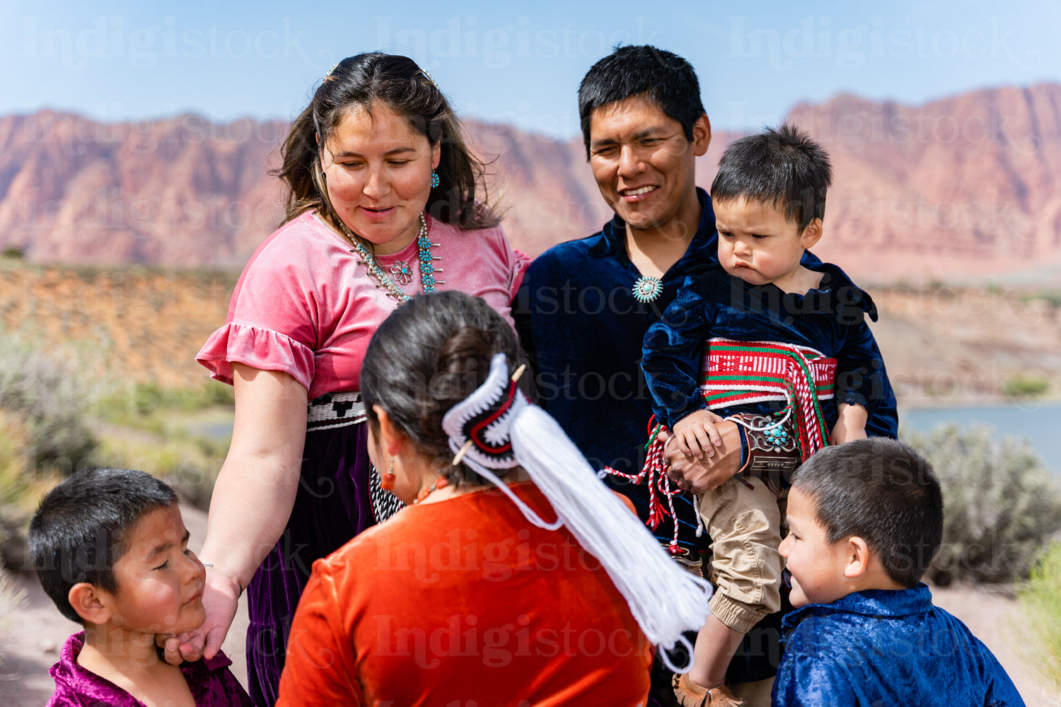 Happy Indigenous family in tradtional regalia outside